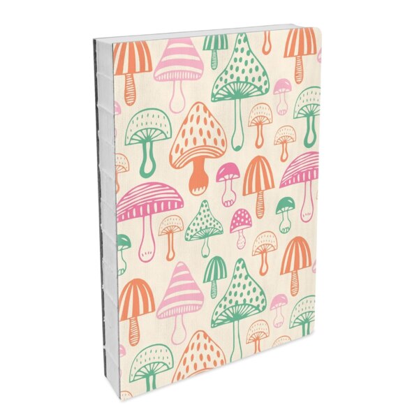 front of hardcover notebook with a slight texture, light tan background with colorful mushrooms all over